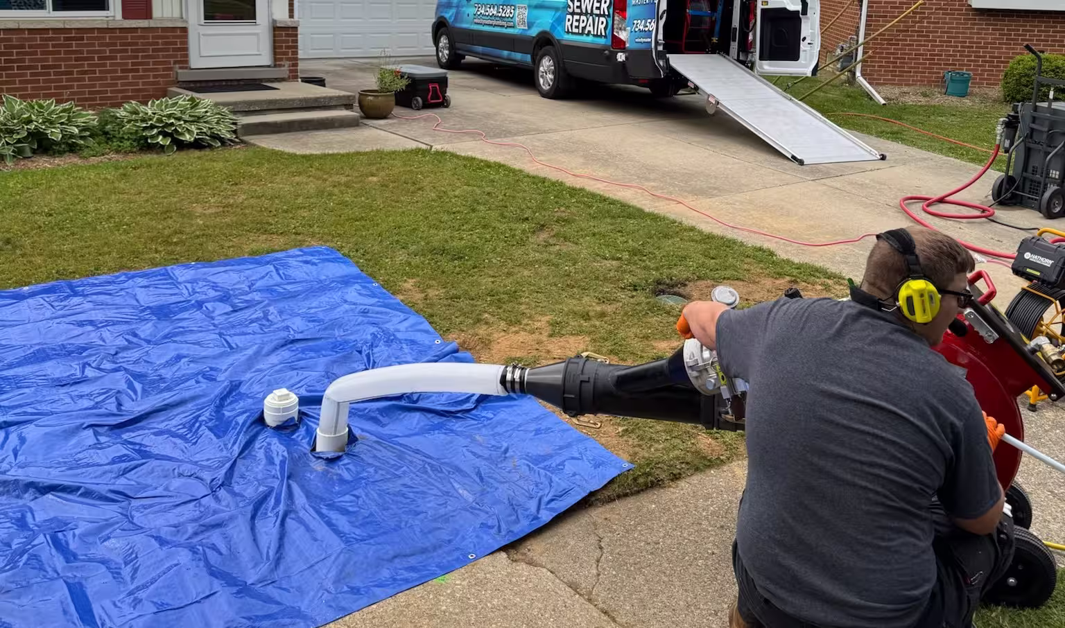 Velocity Master Plumbing & Trenchless Solutions technician performing a trenchless sewer replacement at a residential property.